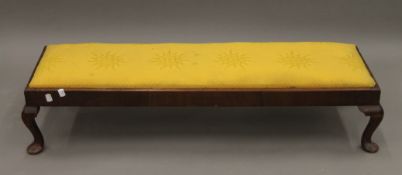 An early 20th century upholstered long foot stool. 107 cm long.