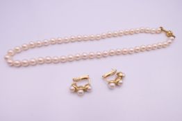 A suite of 18 K gold mounted pearl jewellery, comprising necklace and earrings.