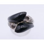 A 14 K white gold diamond and black agate ring. Ring size M/N. 8.9 grammes total weight.
