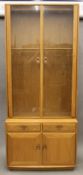 An Ercol blonde oak glazed display cabinet. 213 cm high x 91 cm wide.