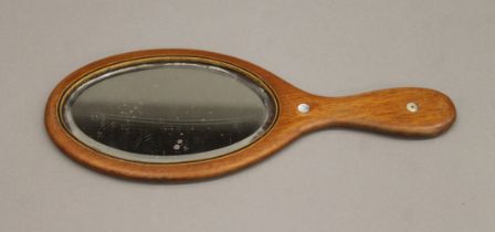 A hand mirror with mother-of-pearl inlay. 30 cm long.
