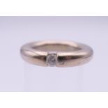 A 14 K white gold diamond solitaire ring. Ring size L. 12.8 grammes total weight.