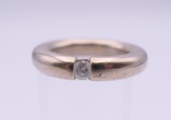 A 14 K white gold diamond solitaire ring. Ring size L. 12.8 grammes total weight.