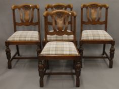 A set of four early 20th century oak dining chairs. 49 cm wide.