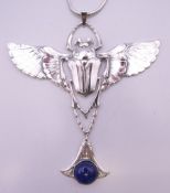 A silver scarab and lapiz pendant on chain. The pendant 9 cm high.
