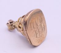 A 9 ct gold fob locket. 2.5 cm high. 6.4 grammes.