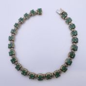 A 9 ct gold green stone bracelet. 19 cm long. 12.6 grammes total weight.