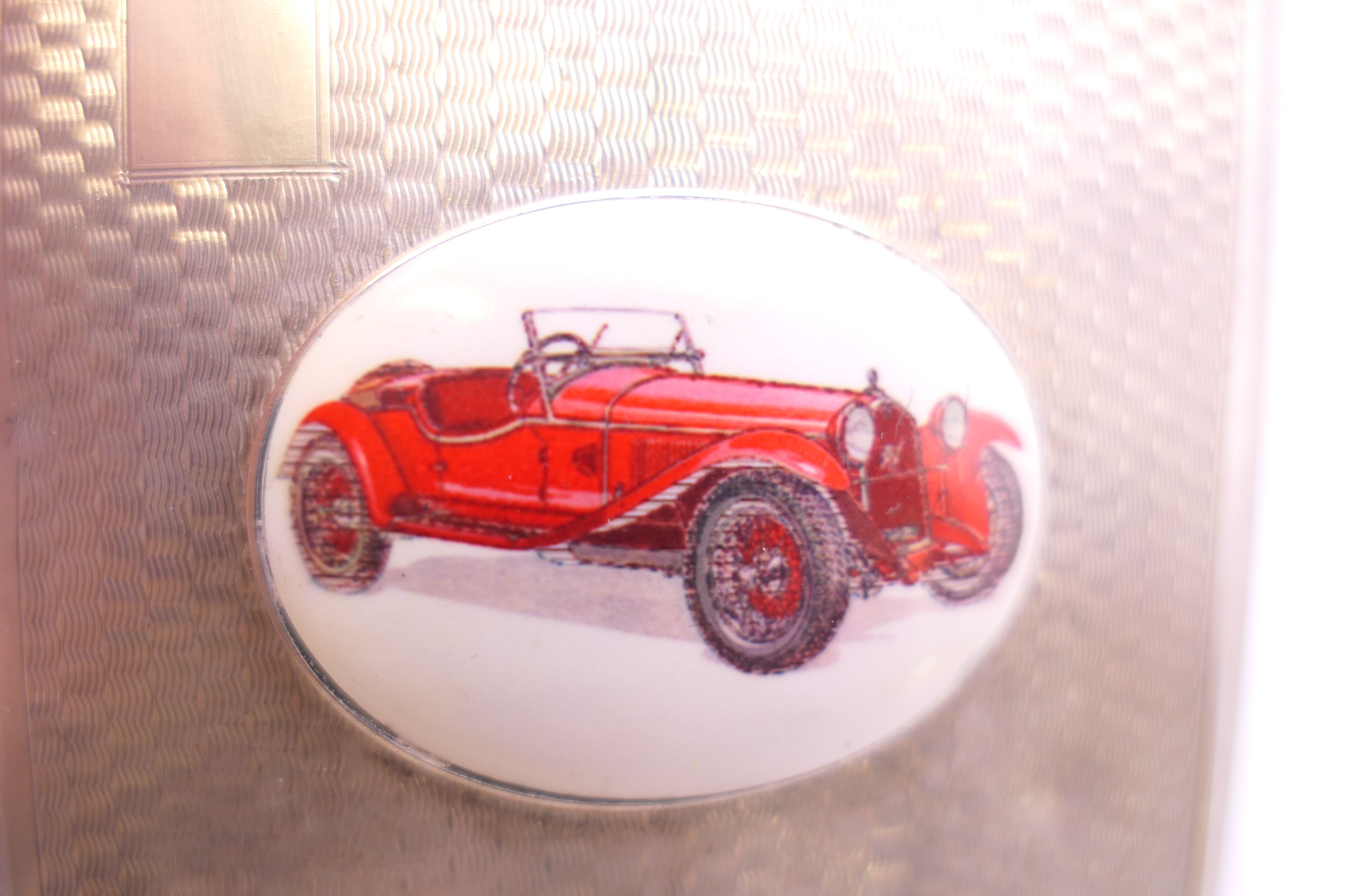 A silver enamel cigarette case decorated with a car. 8 cm wide. - Image 3 of 10