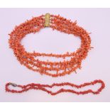 A four strand coral necklace and a single strand coral necklace.