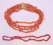 A four strand coral necklace and a single strand coral necklace.