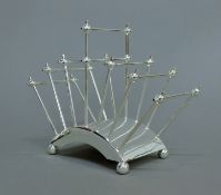 A Christopher Dresser style silver plated toast rack. 17.5 cm high.
