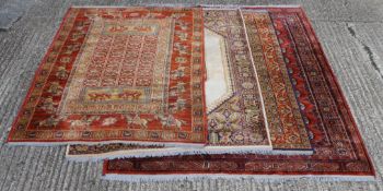 Four various rugs, the largest 175 cm x 225 cm.