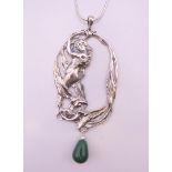 A silver chain with silver art nouveau pendant, the pendant 10 cm high.