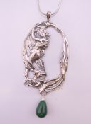 A silver chain with silver art nouveau pendant, the pendant 10 cm high.