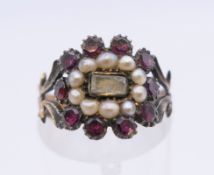 A seed pearl and garnet ring. Ring size L/M.
