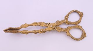 A pair of Victorian gilt grape tongs. 15 cm long.