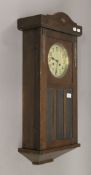 An oak cased wall clock. 76 cm high.