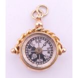 A 9 ct gold fob compass, Chester 1919. 2.5 cm high. 3.7 grammes total weight.