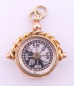 A 9 ct gold fob compass, Chester 1919. 2.5 cm high. 3.7 grammes total weight.