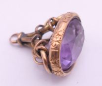 A 9 ct gold and amethyst rope design fob. 2 cm high. 5.2 grammes total weight.