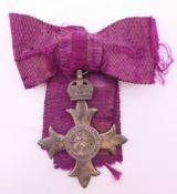 A silver MBE medal. 4.75 cm wide.