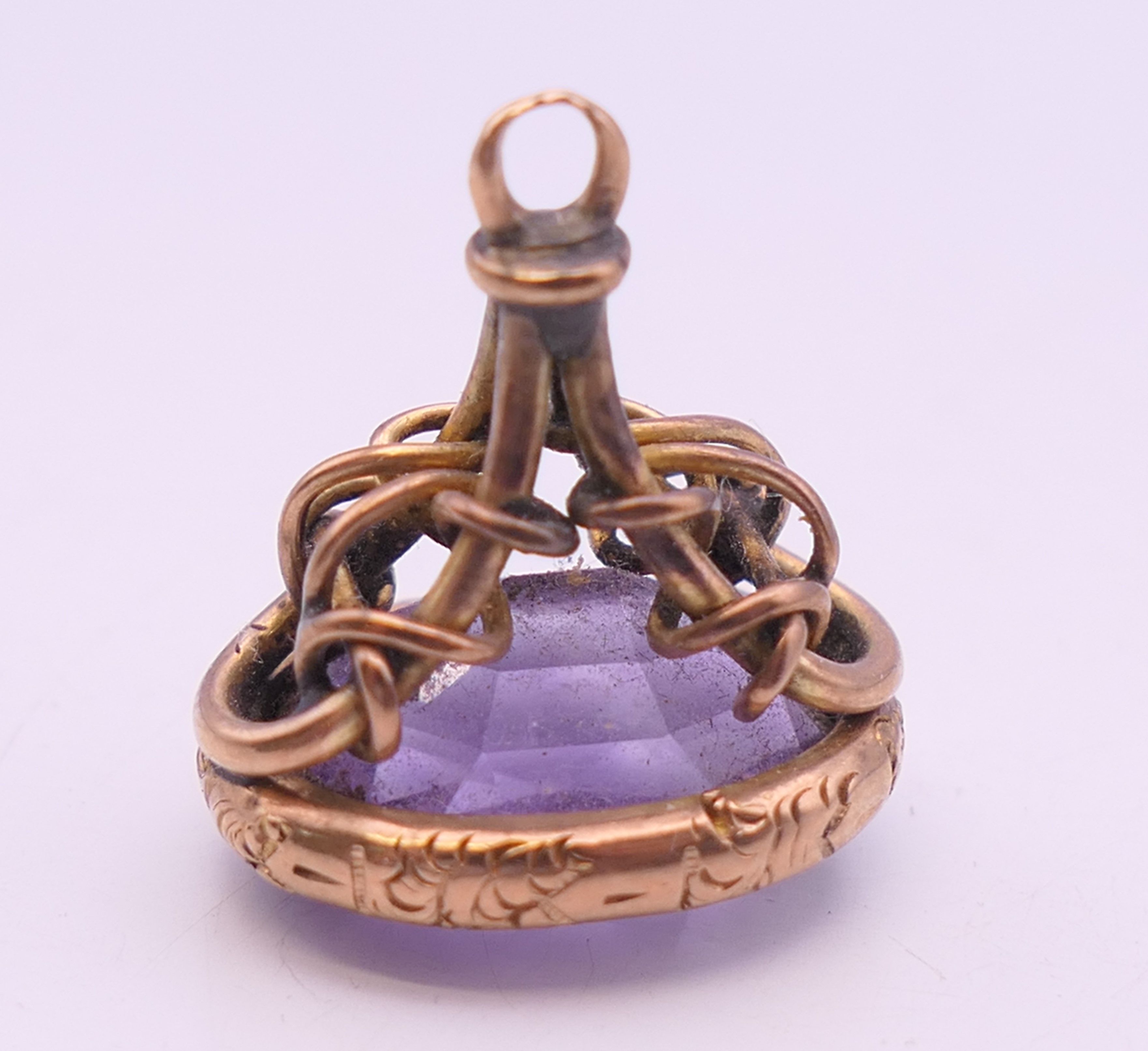 A 9 ct gold and amethyst rope design fob. 2 cm high. 5.2 grammes total weight. - Image 2 of 6