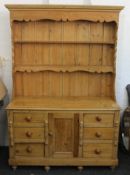 A 19th century and later pine dresser. 139 cm wide, 196 cm high, 50 cm deep.