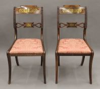 A pair of Regency brass inlaid rosewood chairs. 45 cm wide.