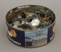 A tin containing wristwatches, etc.
