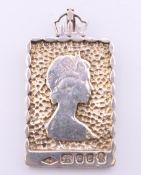 A silver Queen Elizabeth II Silver Jubilee (1977) Commemorative pendant. 4 cm high. 17 grammes.