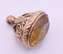 A 9 ct gold and citrine fob. 3 cm high. 10.3 grammes total weight.