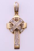 An 18 ct gold and diamond cross pendant. 6.5 cm high. 28.7 grammes total weight.