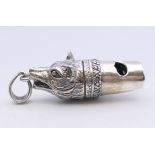 A silver fox mask form whistle. 4 cm long.
