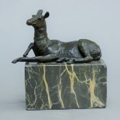 A bronze model of a deer mounted on a marble base. 14 cm long.