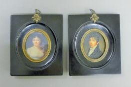 A pair of black framed miniatures. 11 cm wide.