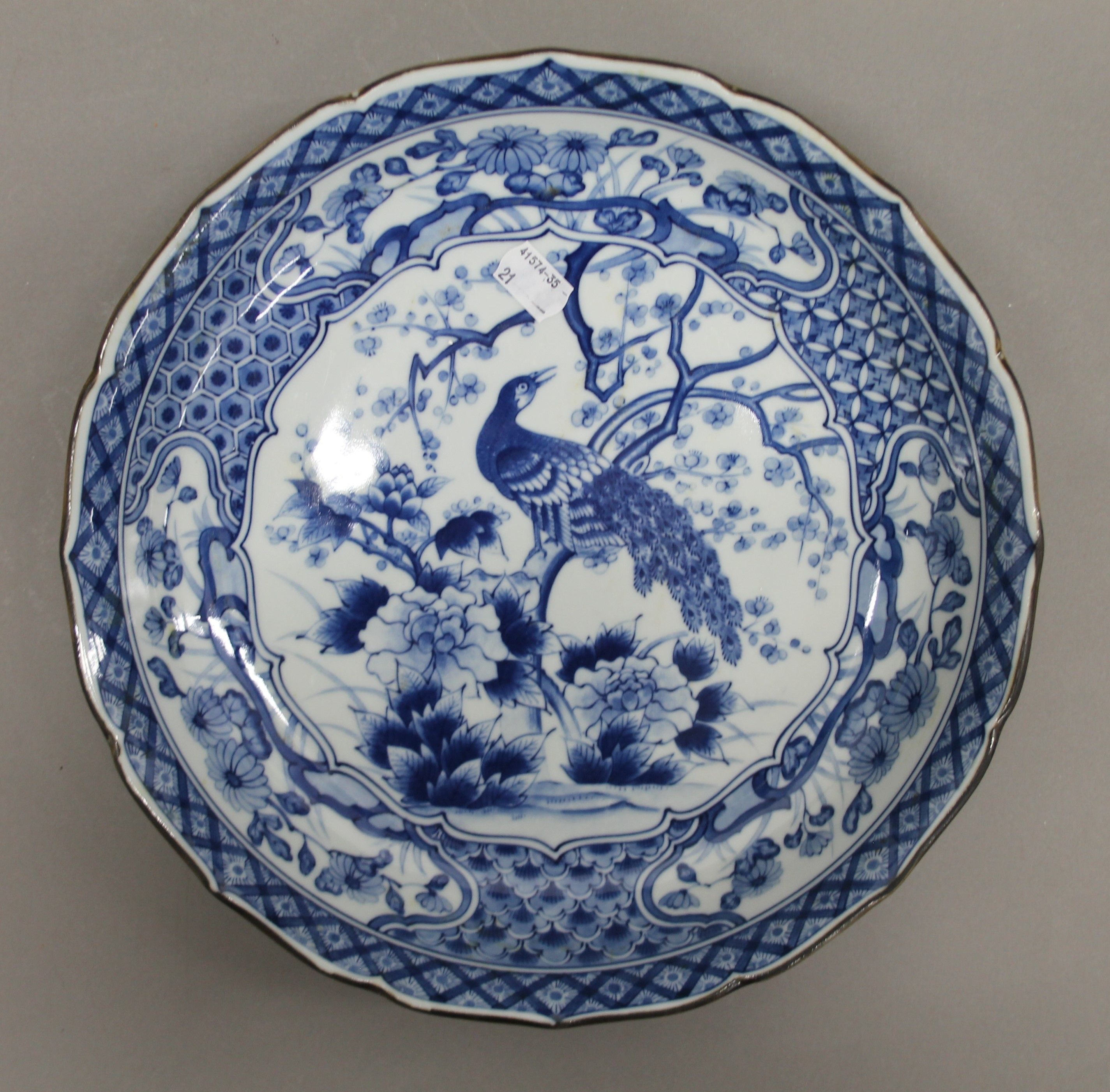 A large Japanese blue and white porcelain dish decorated with peacock perched on blossoming prunus - Image 2 of 4