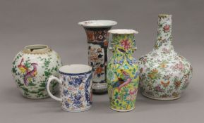 A quantity of antique Oriental vases and an 18th century mug. The largest 30 cm high.
