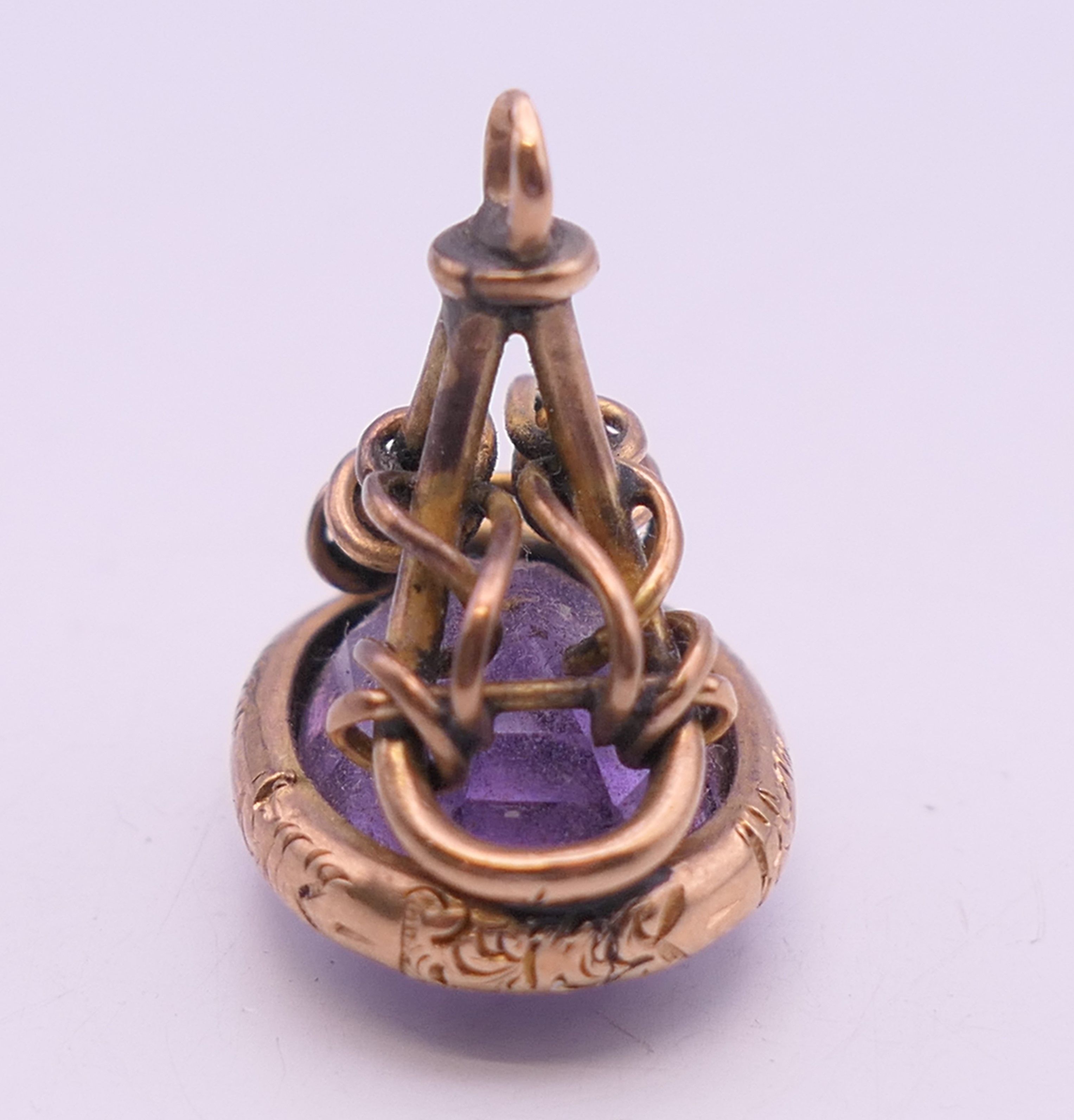 A 9 ct gold and amethyst rope design fob. 2 cm high. 5.2 grammes total weight. - Image 3 of 6