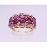 A 9 ct gold ruby and diamond ring. 22 mm x 11 mm. Ring size S. 4.1 grammes total weight.