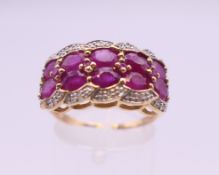 A 9 ct gold ruby and diamond ring. 22 mm x 11 mm. Ring size S. 4.1 grammes total weight.