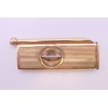 A 9 ct gold cigar piercer and cutter. 6 cm long. 14.