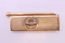 A 9 ct gold cigar piercer and cutter. 6 cm long. 14.