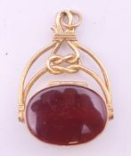 A 9 ct gold bloodstone and carnelian swing fob. 3.5 cm high. 7.6 grammes total weight.