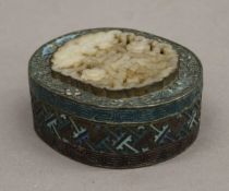 A late 19th/early 20th century Chinese enamel decorated box set with a jade carving. 8 cm long.