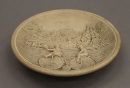 A Victorian round wall plaque decorated with steam train and penny farthing cyclists. 16.