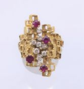 An 18 K gold diamond and ruby ring. Ring size N/O, 14.6 grams total weight.