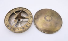 A brass cased pocket sundial compass marked Alment, Dublin. 7.25 cm diameter.