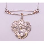 A silver necklace with Art Nouveau style pendant. The pendant 5 cm high.