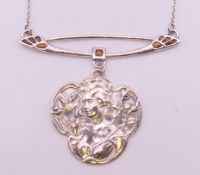A silver necklace with Art Nouveau style pendant. The pendant 5 cm high.