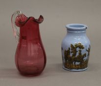 A cranberry glass jug and Prattware pot. The former 13 cm high.